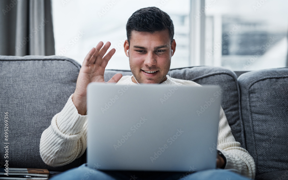 Aufkleber Catching up from the safety and comfort of home. Shot of a young man using a laptop to make a video call while working from home.