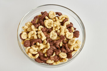 Granola in a transparent bowl on a white background. Healthy food. Baby food.