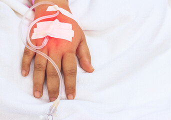 Close up IV infusion in a child patients hand,Close up Children patient's hand recieving iv saline...