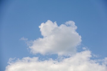 Cumulus clouds against the blue sky. Heavenly natural background