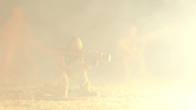 Smoke envelops a plastic toy soldier grenade launcher. The concept of firing a grenade launcher
