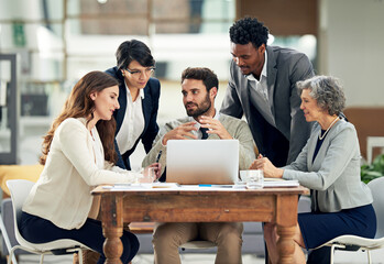 Weighing up all the options. Cropped shot of a group of businesspeople meeting in the boardroom.