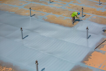 Top view male worker holding an industrial spray gun used for roof plate tank surface on steel industrial painting © chitsanupong