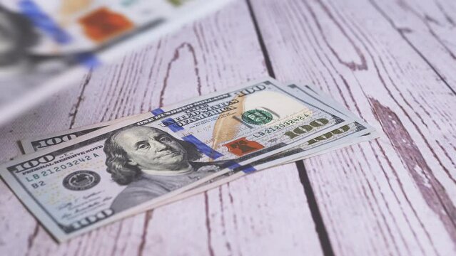 Female Hands are Counting a Stack of 100 Dollar Bills, Leafing through Banknotes. Close-up. Bribe, dirty money, profit. Concept of making money. Accumulated capital. Financial planning, savings. 4K.
