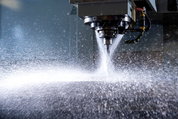 Close-up of industrial drill being sprayed with water.