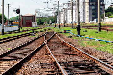 Fototapeta na wymiar Railway tracks near high-rise buildings of the railway station