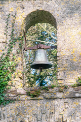Fototapeta premium Old brass bell in the arc of gate