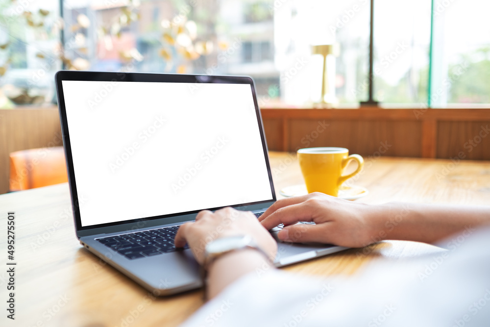 Wall mural mockup image of a woman using and working on laptop touchpad with blank white desktop screen
