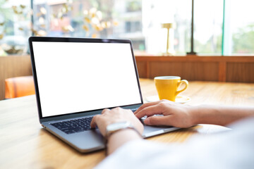 Mockup image of a woman using and working on laptop touchpad with blank white desktop screen