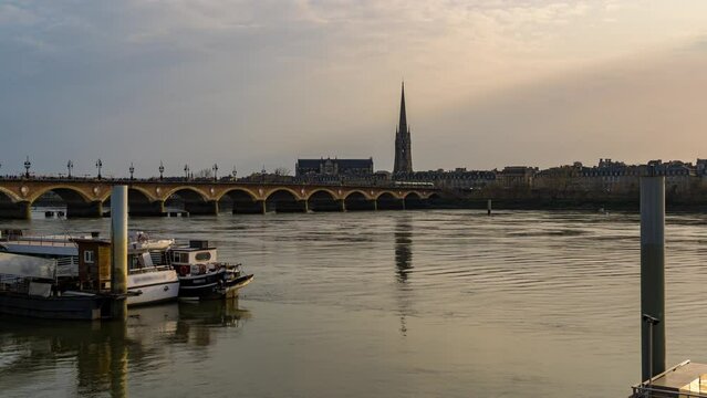 Bordeaux at Day with Clouds Stone Bridge Saint-Michel Basilica Garonne River Boats