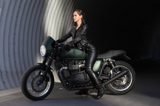woma in black with a motorcycle