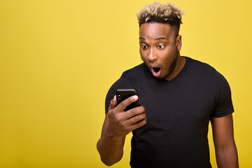 Stylish guy in black T-shirt received strange message on his smartphone and was very surprised by...