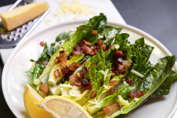 Cos lettuce salad with crispy bacon, and parmesan cheese. Easy healthy recipes. 