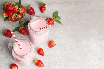 Fototapeta na wymiar A glass of fresh strawberry smoothie on a pink background. Summer drink shake, milkshake and refreshment organic concept.