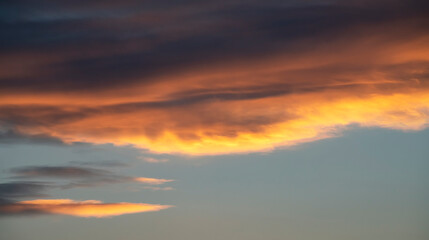 Fototapeta na wymiar Beautiful dark golden sunset sky with clouds. Sky background.