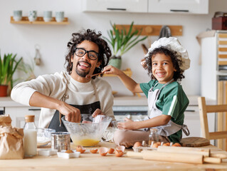 Black man and son cooking together in kitchen