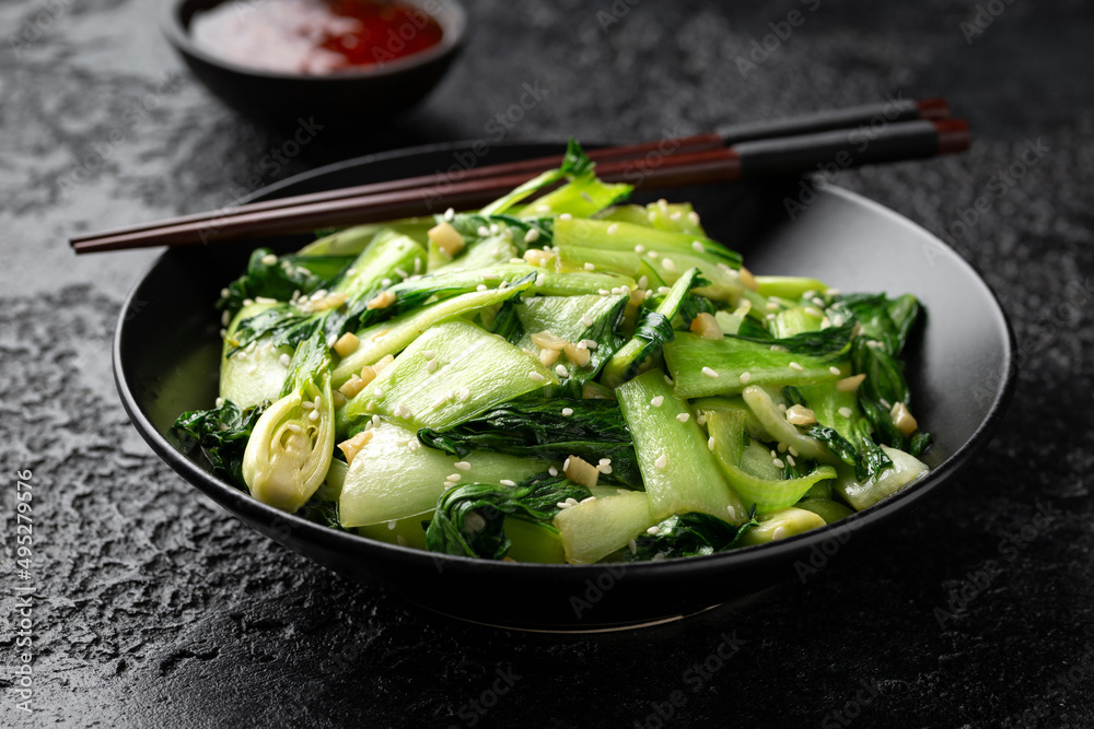 Wall mural chinese fried pak choi with garlic, sesame seeds. healthy food