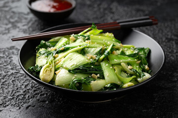 Chinese fried Pak Choi with garlic, sesame seeds. Healthy food - obrazy, fototapety, plakaty