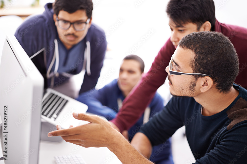 Poster Collaborative coding. Shot of a group of colleagues working together with a computer in an office.