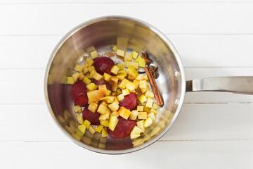 Ingredients fruit topping in saute pan on white background.