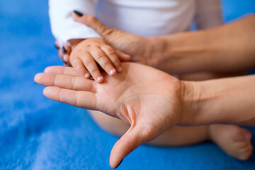 Children's hand on the palm of a woman