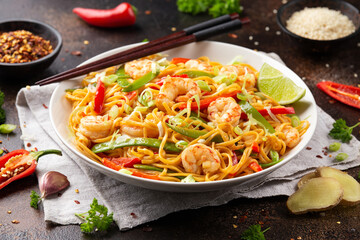 Stir fry noodles with prawns and vegetables in white plate. Healthy asian food
