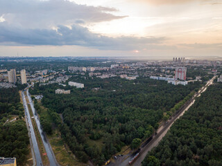 Fototapeta premium Sunset over Kiev. Rain clouds in the sky. Aerial drone view.