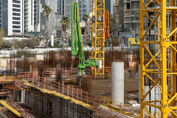 Beginning Laborers works Concrete pillars  on the construction site of a  modern skyscraper in...