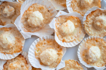 Plate with delicacy roasted scallops with cheese