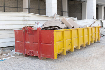 a huge heap of  waste in a Big Overloaded dumpster waste metal container filled with construction...