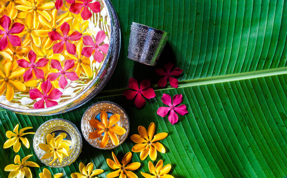 Pure water bowls decorating with flowers and perfume, on banana leaf for Lao New Year or "Pi Mai Lao". Songkran festival.