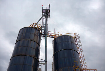 industrial silo storage factory building container cloudy sky