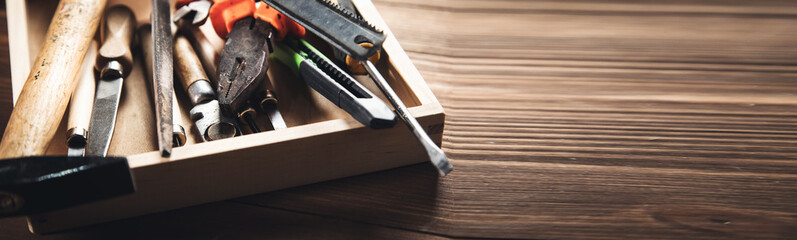 different construction tools on wooden background - obrazy, fototapety, plakaty