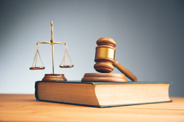 wooden judge gavel with law book