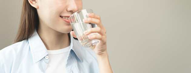 Clean freshwater concept. Woman drink mineral water in the morning for good health.