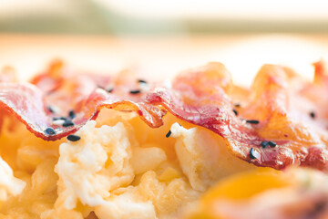 Scrambled eggs with bacon avocado and orange juice