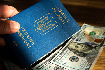 Ukrainian passport on a background of dollars