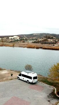 Aerial view of caravan parked by lake
