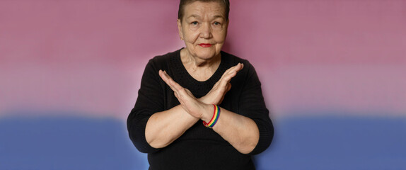 Elderly woman makes a sign BreakTheBias with her arms crossed.  Feminism, International women's day, 8, BreakTheBias. Gender equal, diverse, equitable, and inclusive world