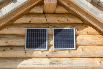 Detail of mountain hut with solar panels under the roof.