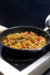 Pisto manchego de verduras en la sartén cocinándose