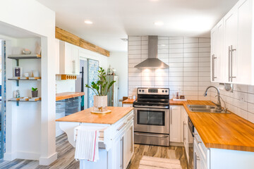 A minimalist white kitchen with wood details 