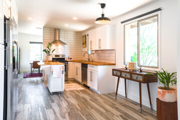 A minimalist white kitchen with wood details 