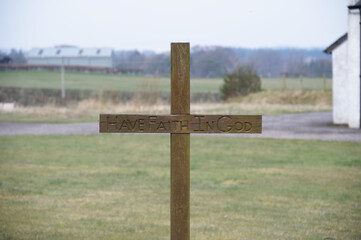 Have Faith in God engraving on wooden cross