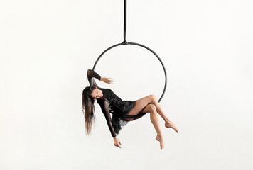 Graceful gymnastic woman performing on aerial hoop © photology1971