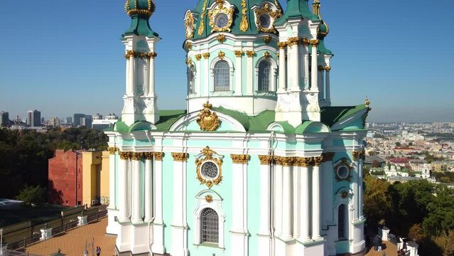 Kyiv, Ukraine - 10/04/2021: Aerial view of Andriivska Church and historical part of Kyiv - Podil, religious architecture in baroque style. Tourist place and attractions 
