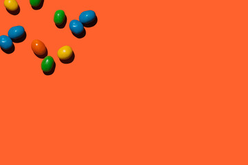 colorful candies on orange background