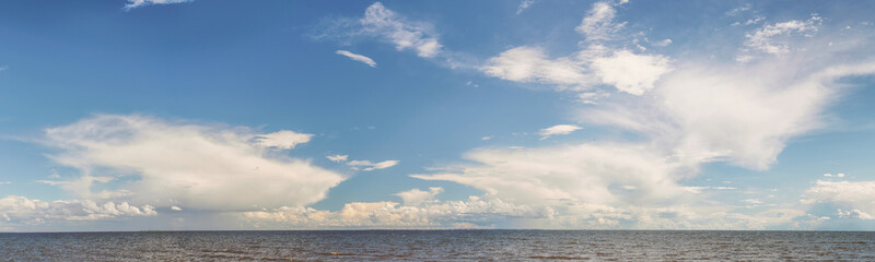 Fototapeta na wymiar Cloudy sky and horizon over rough sea in windy weather