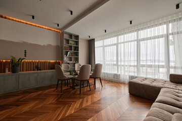 Modern interior of studio apartment in gray and brown colors and tones. chandeliers. Expensive and luxury design