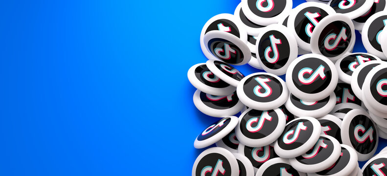 Logos of the TikTok on a heap. Copy space. Web banner format.